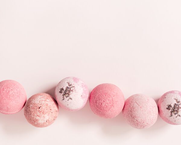 A pink string of beads on top of a white table.