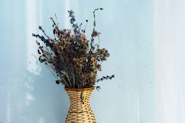 A vase with flowers in it on the wall